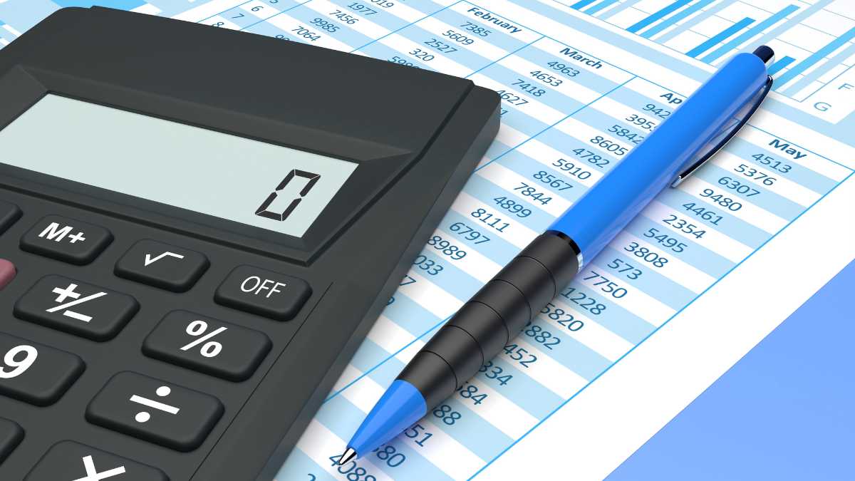 Calculator and pen on a financial spreadsheet with numerical data