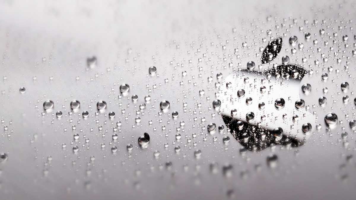 Apple logo with water droplets on a surface