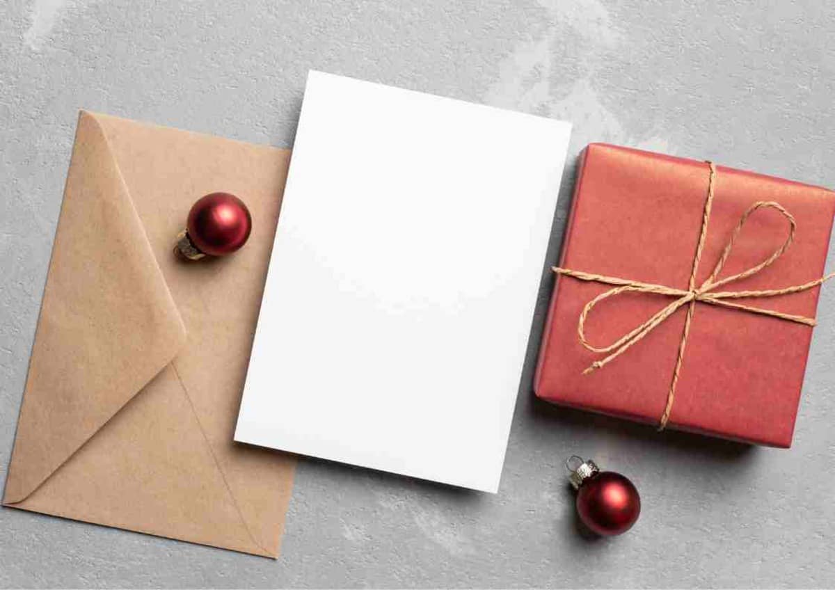 Blank card with envelope and gift box suggesting a festive or gift giving theme