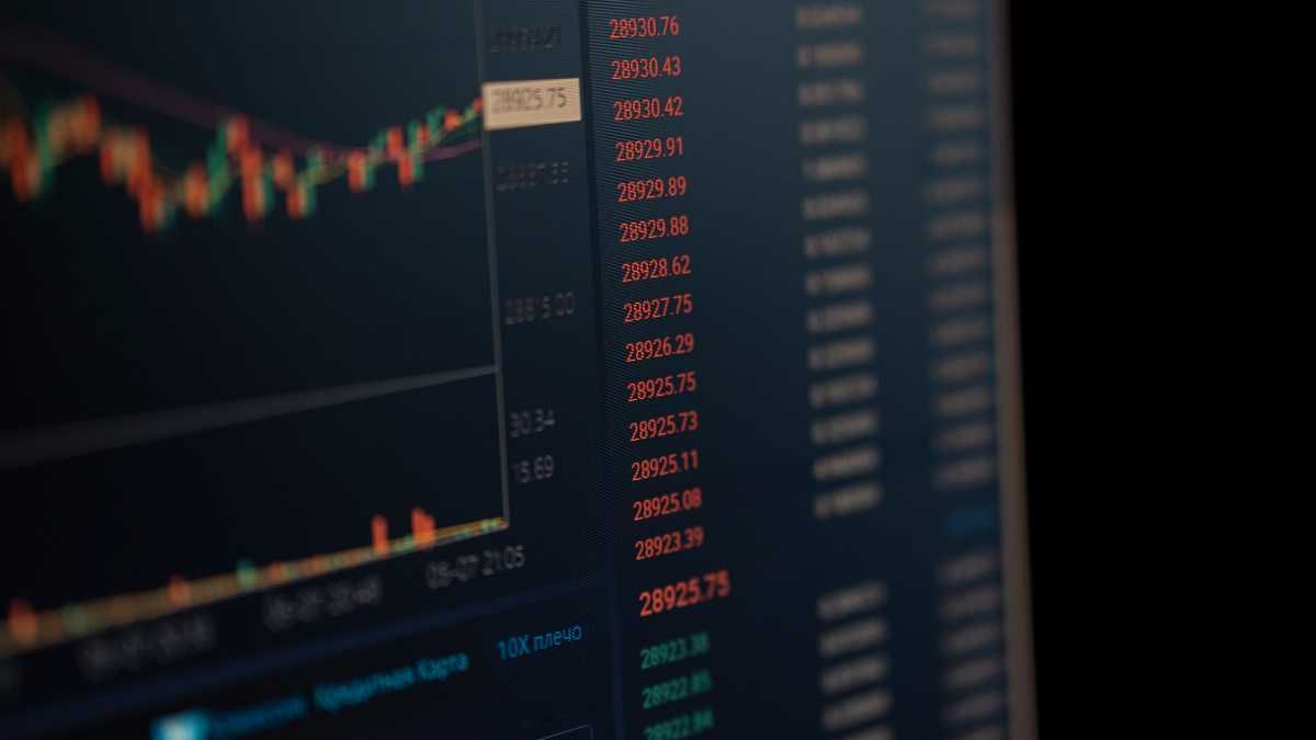 Stock market graph on dark screen background