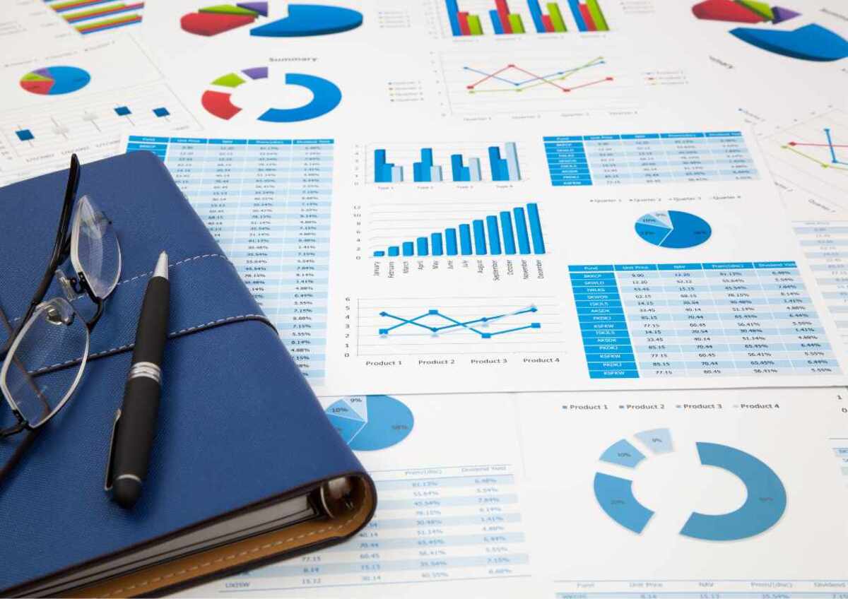 Eyeglasses and pen on financial charts.