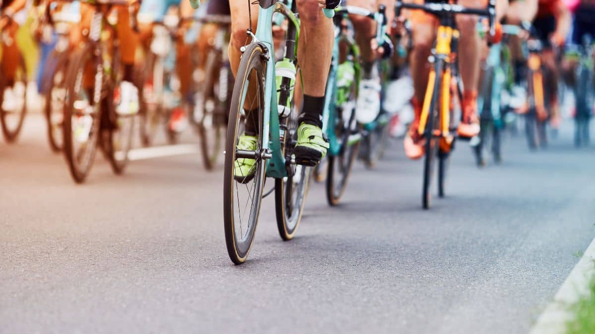 a group of cyclists in a road race or group ride The focus is on the lower half of the riders and their bikes