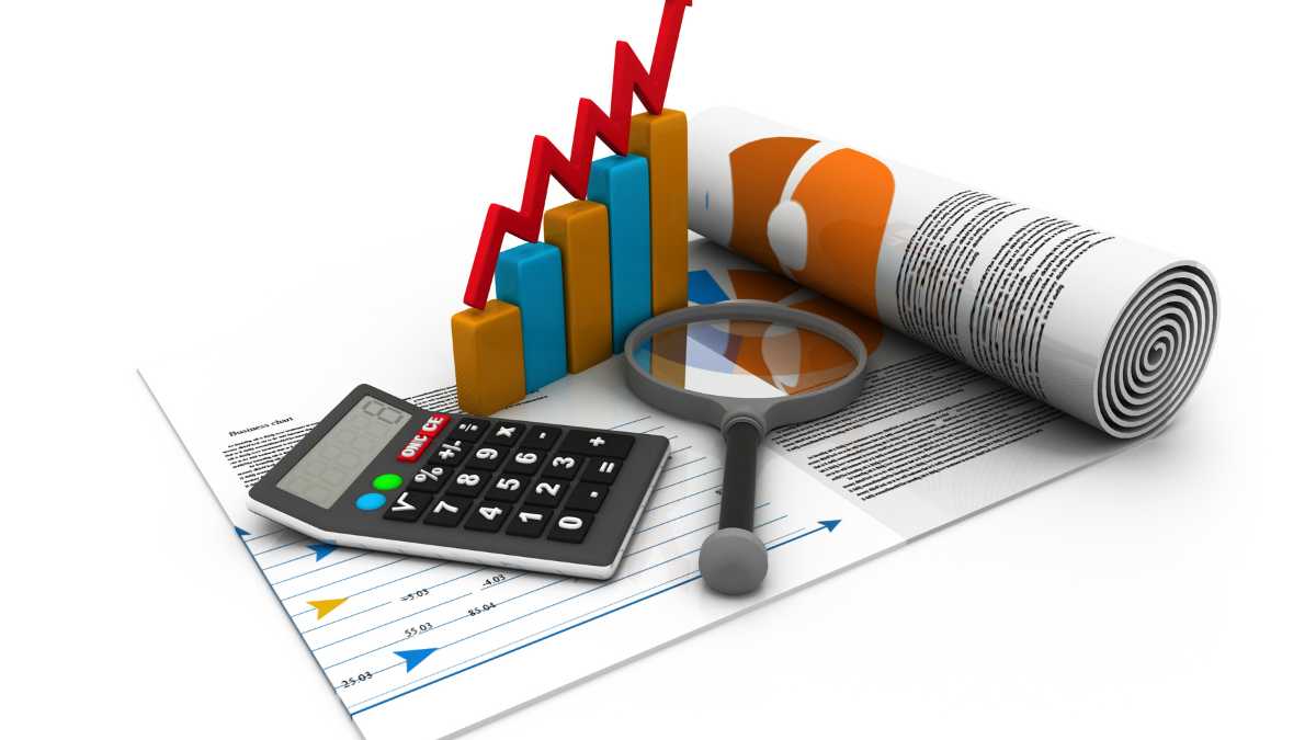 Financial growth charts with calculator and magnifying glass