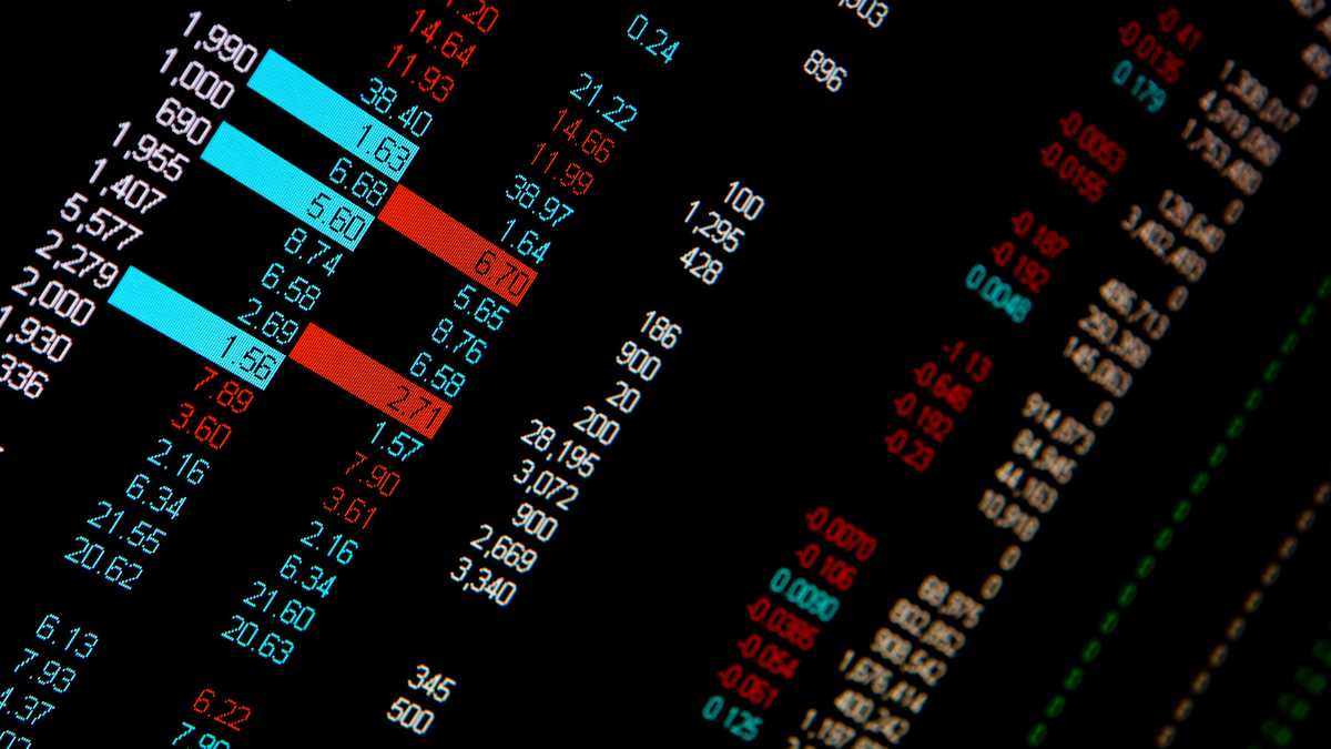 A close up view of a stock market tracking screen with red and blue numbers