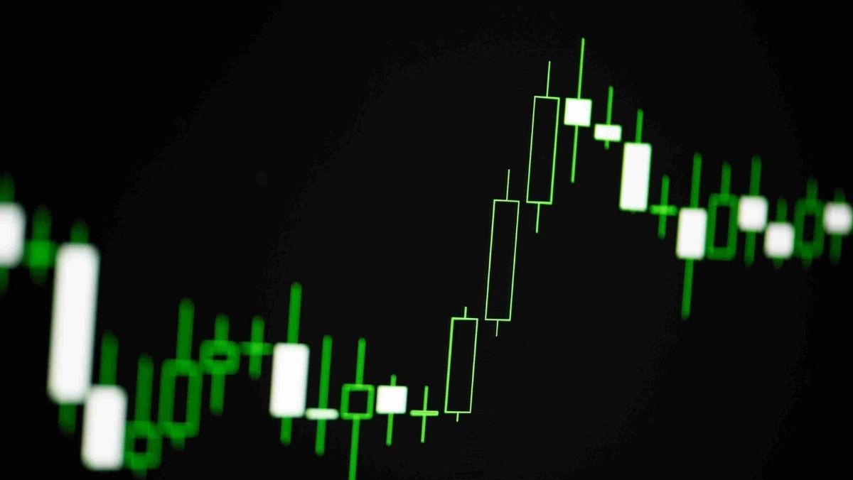 A green and white candlestick pattern against a black backdrop