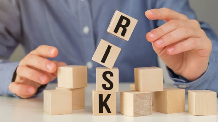 man moving blocks with the word risk