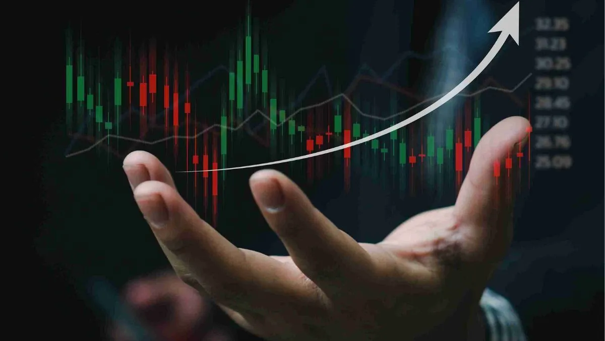 A hand holding a holographic representation of a trading chart