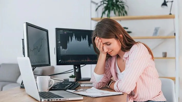 A lady feeling stressed and emotional during trading