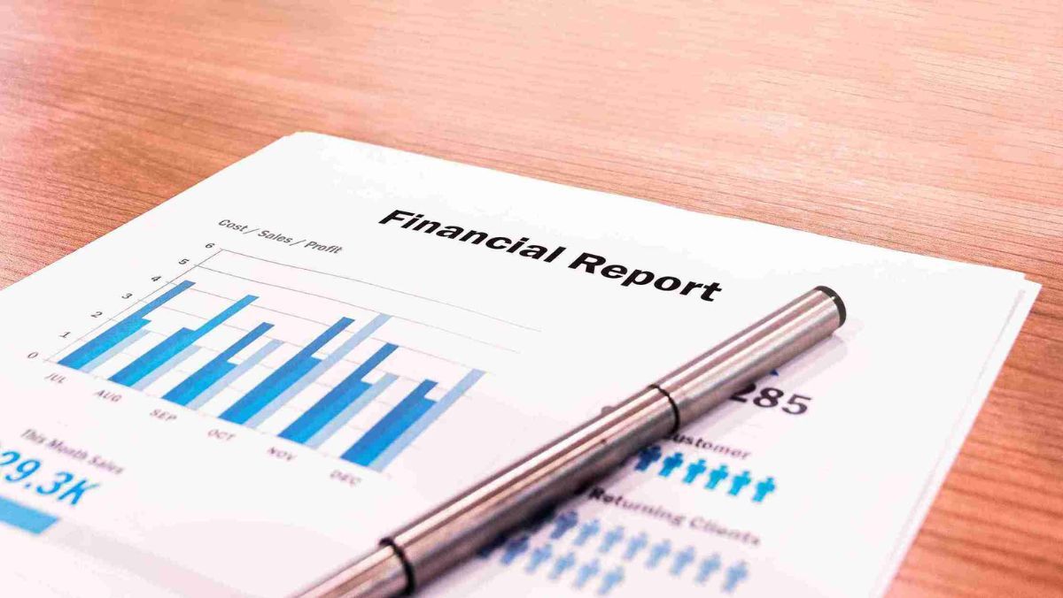 Financial report papers and a pen laid out on the table