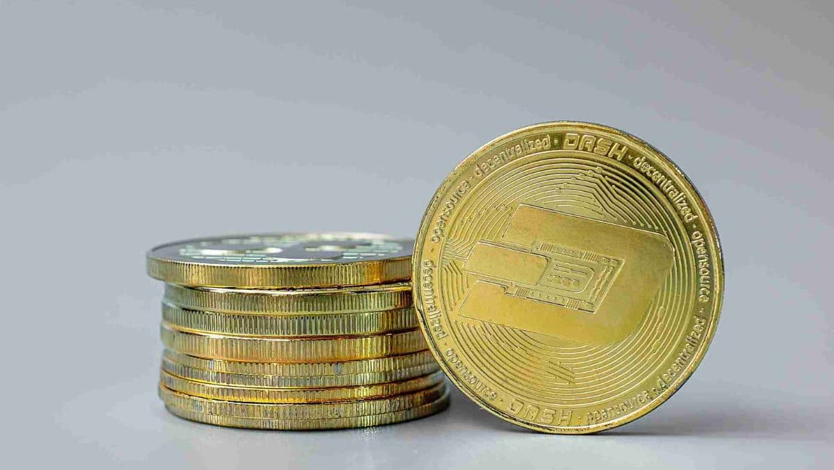 Golden DASH cryptocurrencies positioned against a neutral background