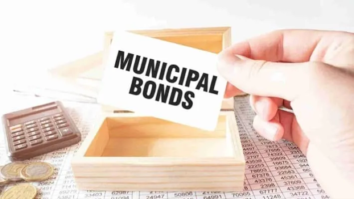 A man holding a white card displaying the words 'municipal bonds'