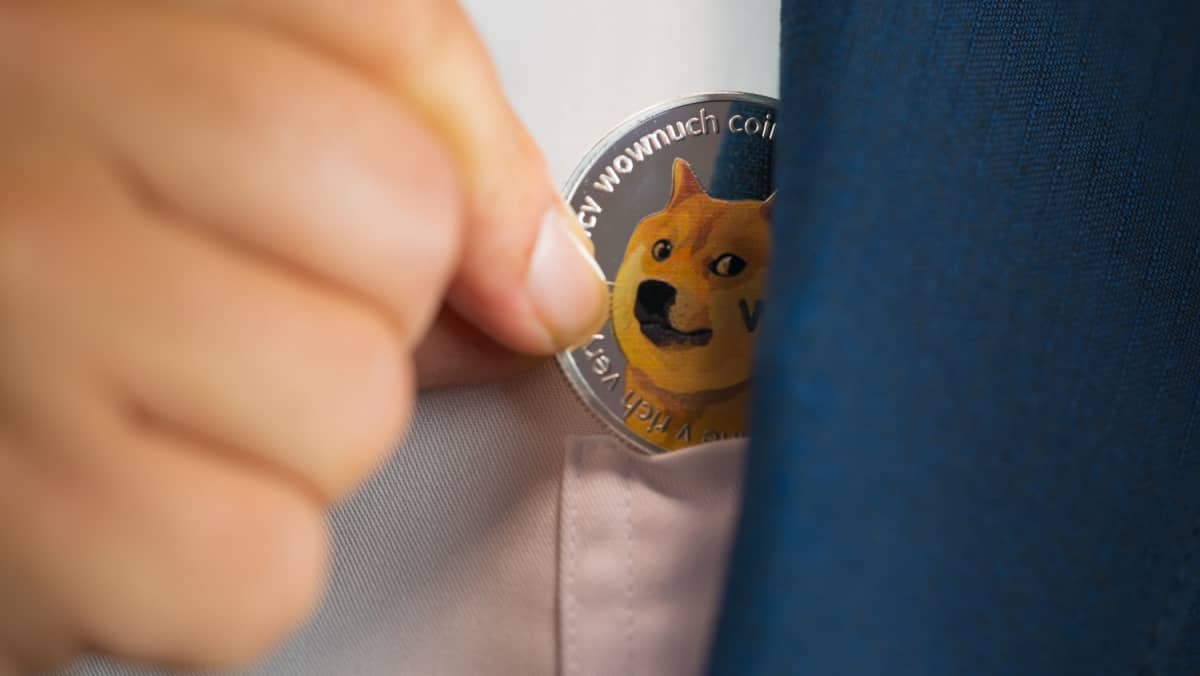 Man in blue suit showing Dogecoin tucked into his clothings small pocket