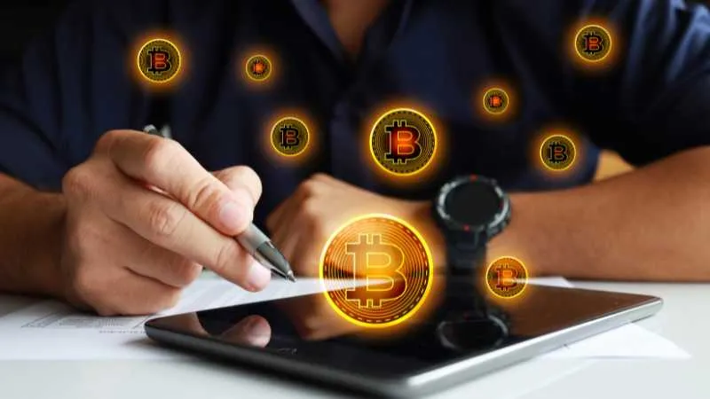 Signing document, tablet with Bitcoin symbol, floating Bitcoin icons