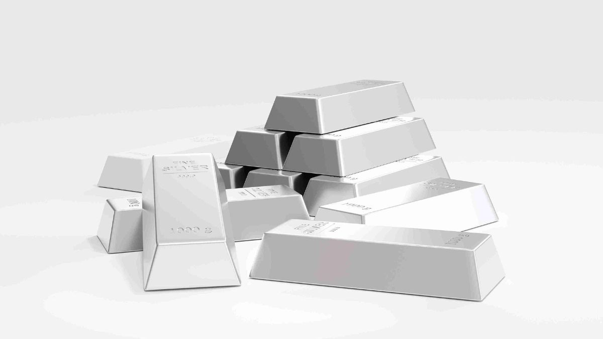 Stack of silver bars against a clean white surface