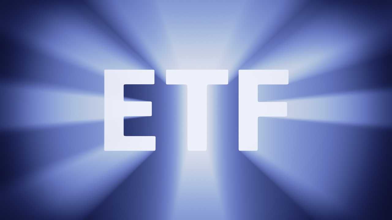 The letters  ETF  in white with a radiant blue background