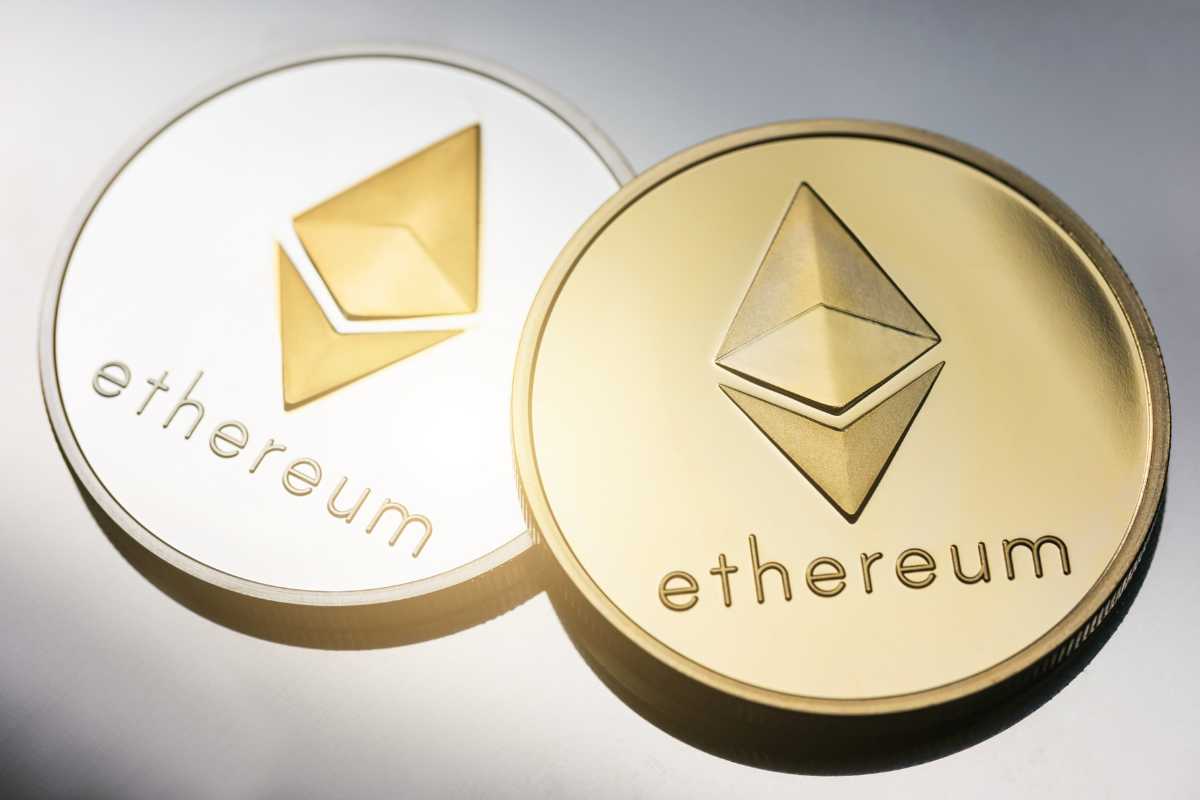 Two golden Ethereum coins on a surface