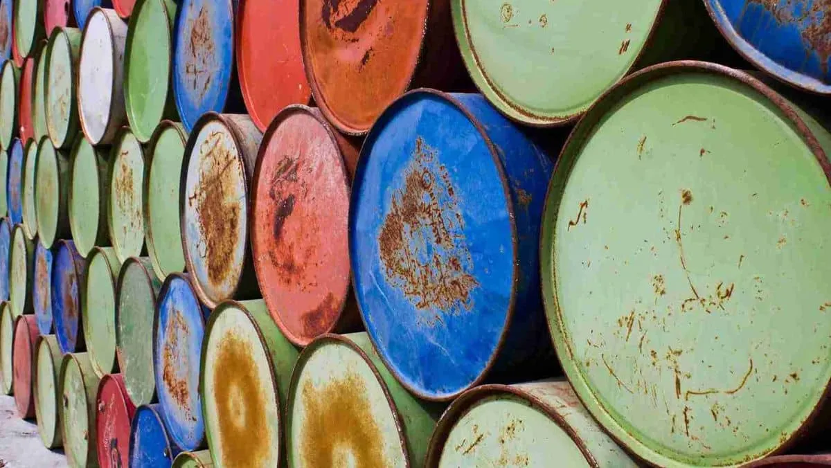 Weathered and rusty oil barrels organized in a designated area