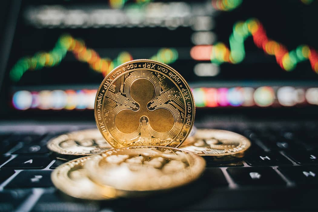 XRP coin with market charts, symbolizing the XRP rally prediction in 2025.