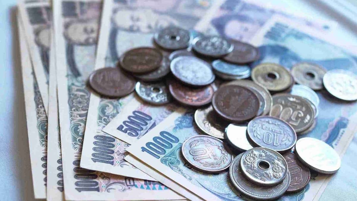 Yen bills and coins spread out on a table