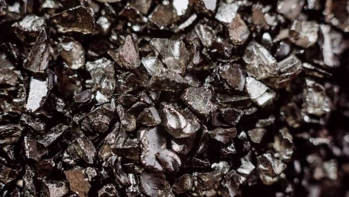 Macro close-up of metallic crystals, possibly a mineral or alloy with reflective surfaces