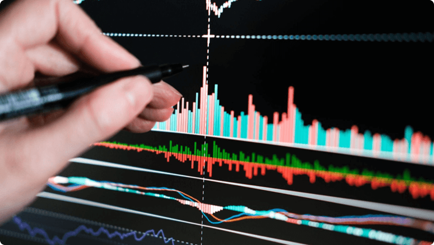 man pointing a trading indicator on screen