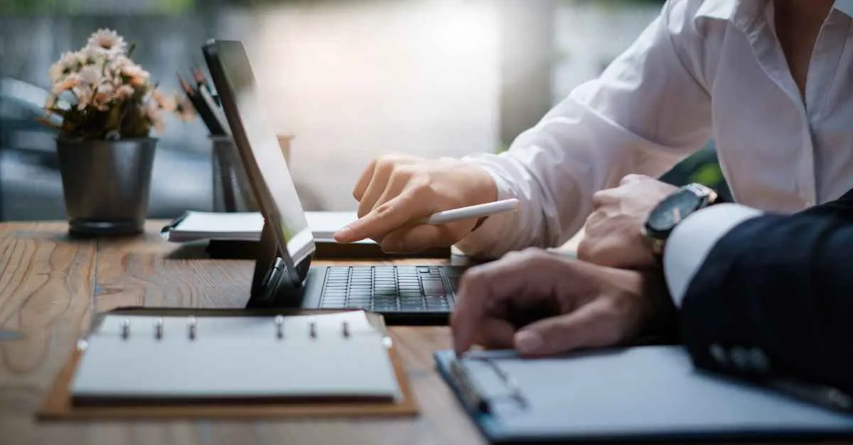 A person pointing at a computer screen